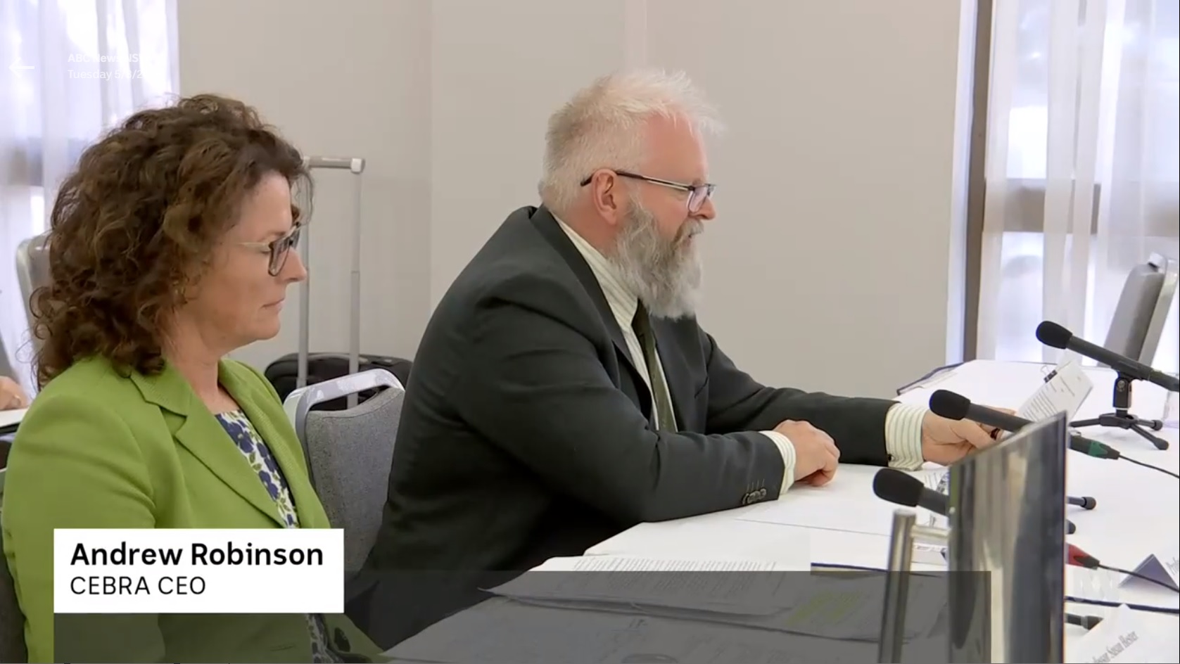 CEBRA CEO Andrew Robinson and Deputy CEO Susie Hester are seated at a desk as they present at the hearing of the Senate Standing Committee on Rural and Regional Affairs and Transport on red imported fire ant