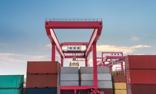 Banner image of shipping containers with gantry crane