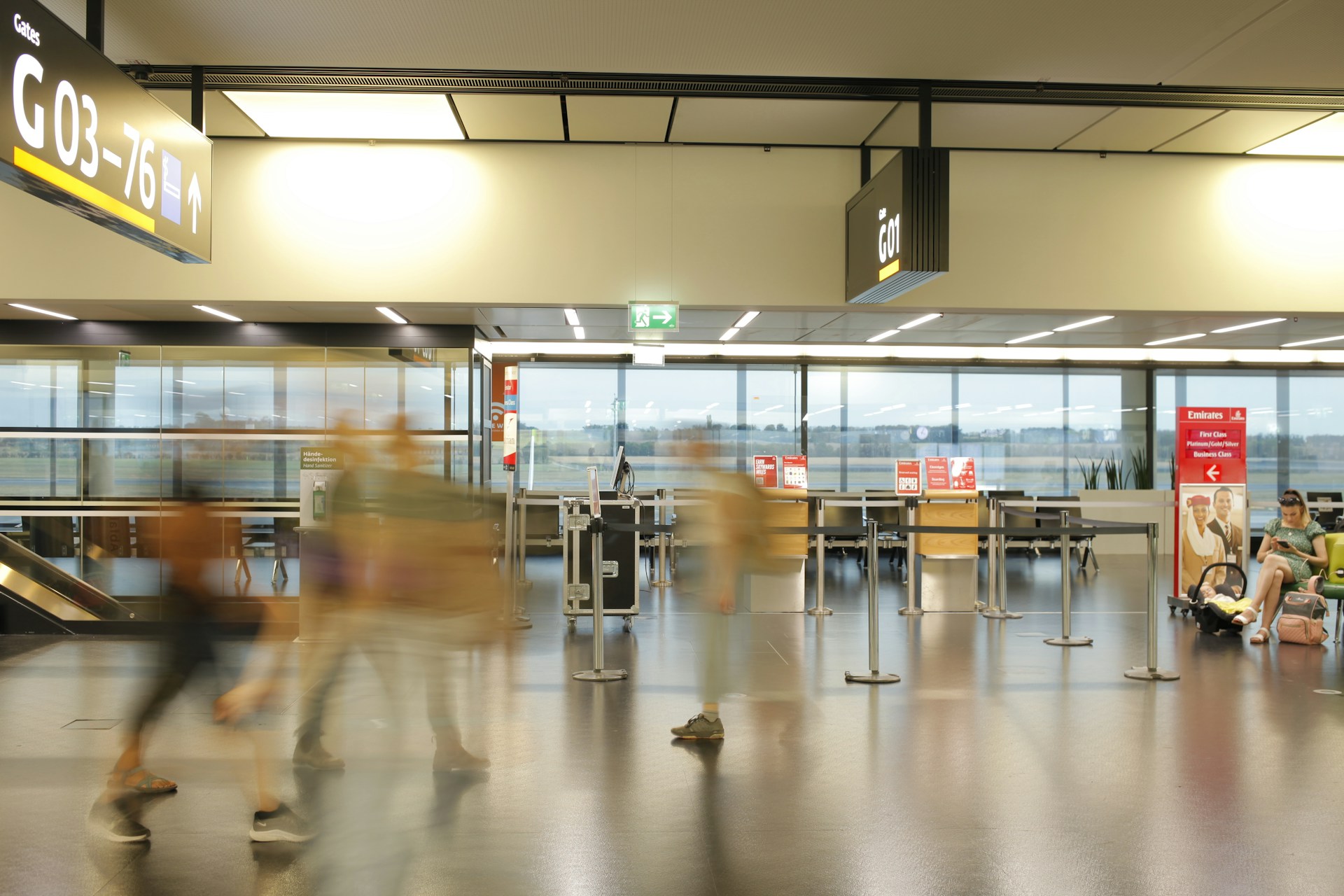 Passengers walking through an airport. 